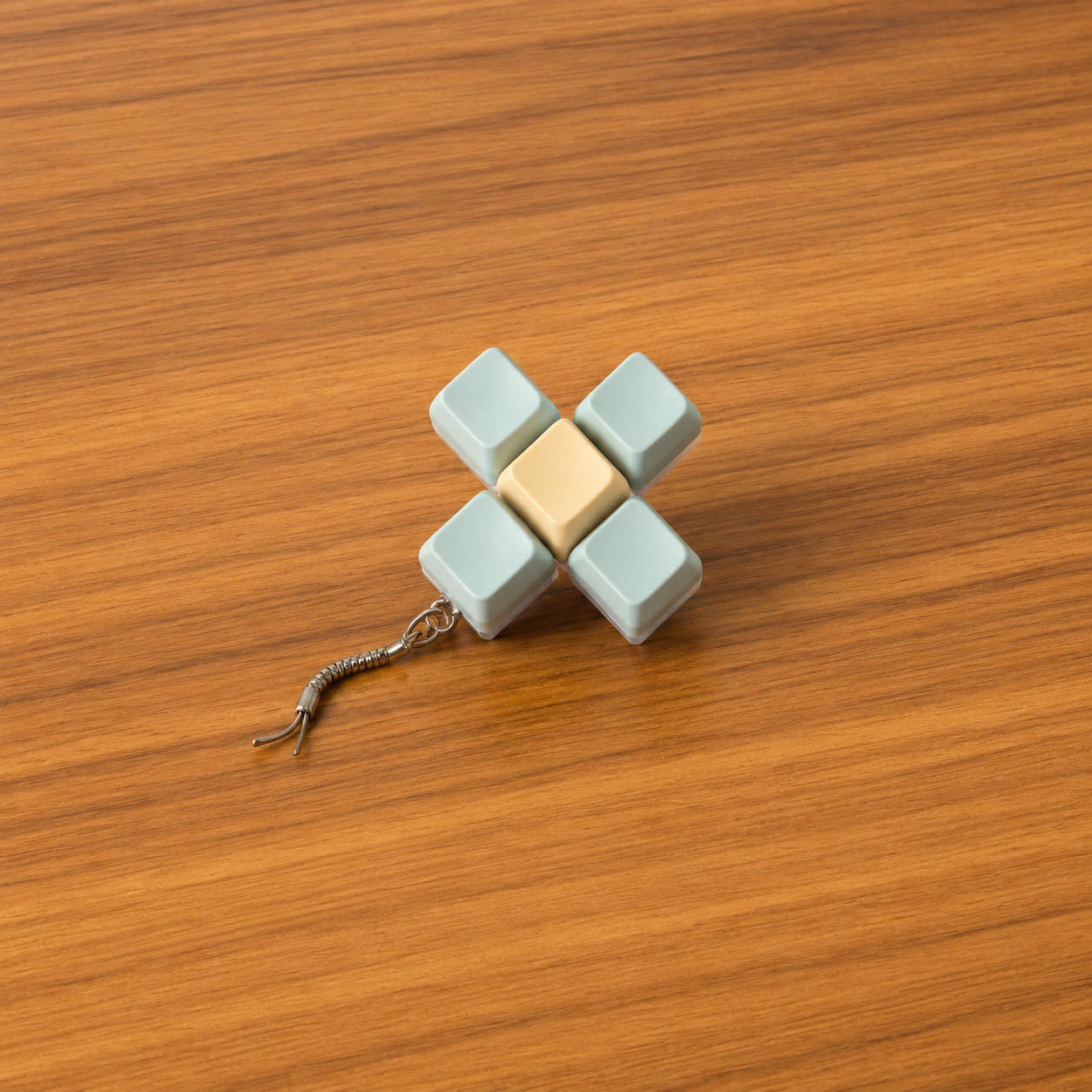 5pc light blue and yellow clicky keyboard keychain on a wooden surface