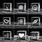 Collection of 3D laser-engraved crystal blocks with various designs on a black background.