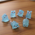 Set of blue cartoonish animal figurines on a table