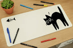 White mouse pad with black cat design on a wooden surface
