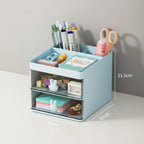 Small desk organizer with stationery items on a wooden surface and blue wall background