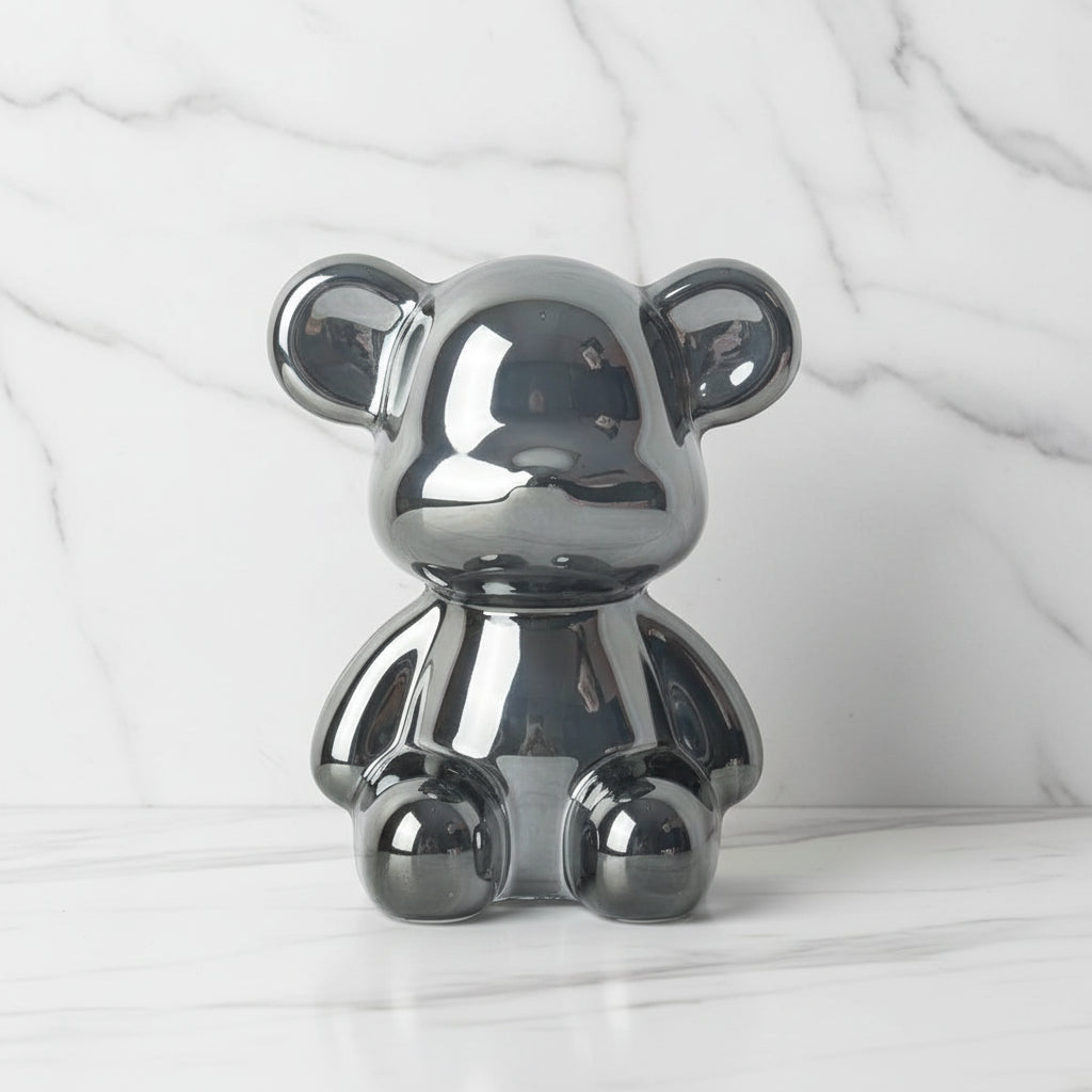 Metallic teddy bear figurine on a white background