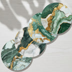 Round marble coasters with green and gold patterns on a gray surface.