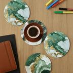 Green marble coasters with a cup of coffee on a wooden table.