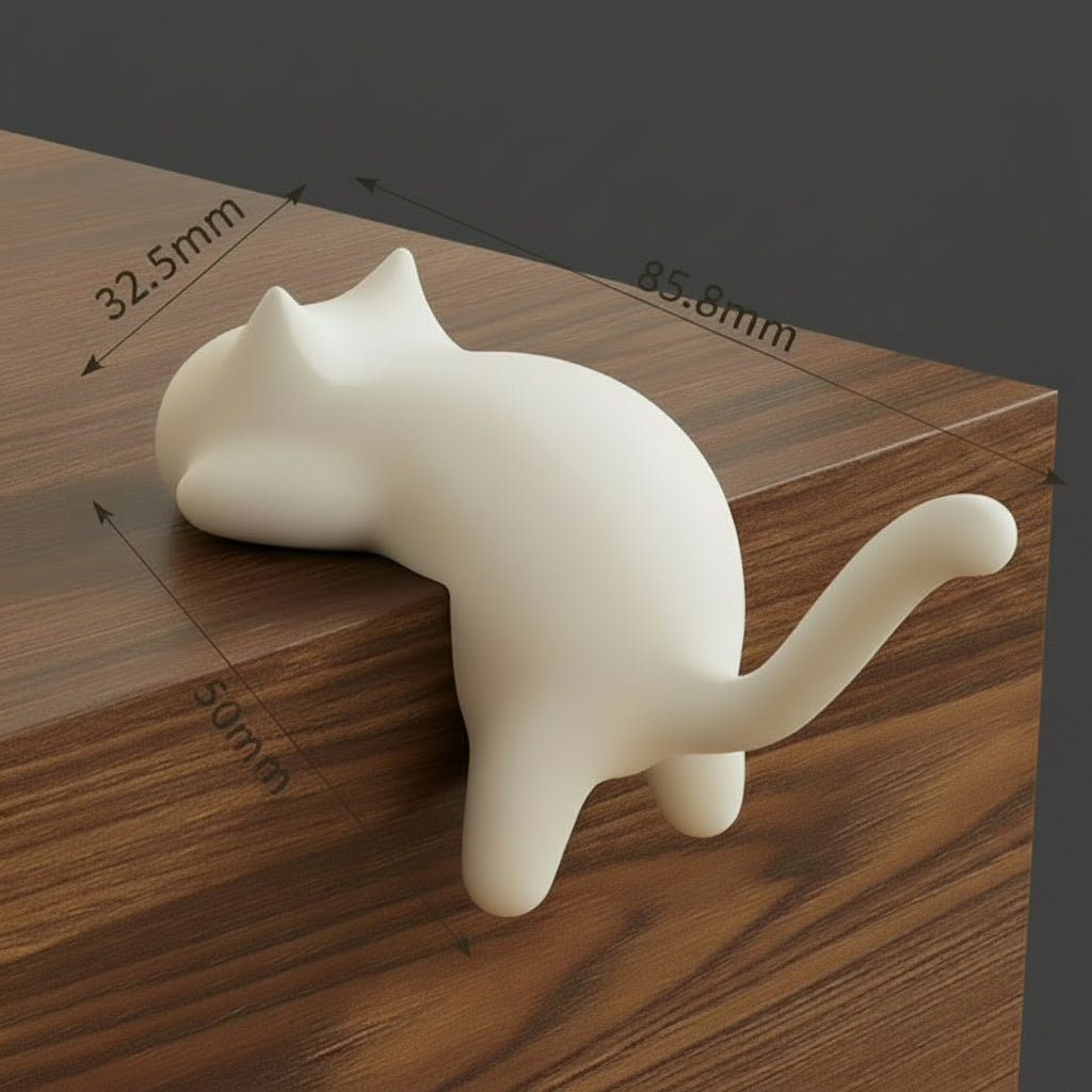 White cat-shaped object with measurements on a wooden surface