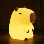 Cute animal-shaped night light on a wooden surface with a warm yellow background