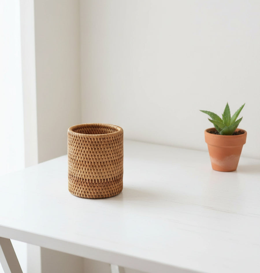 Woven basket on a wooden surface with a white background