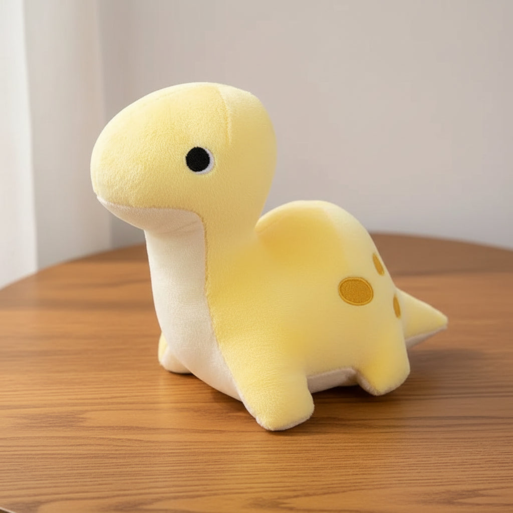 Yellow plush dinosaur toy on a light gray background