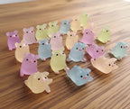 Collection of small, colorful glow in the dark pigs