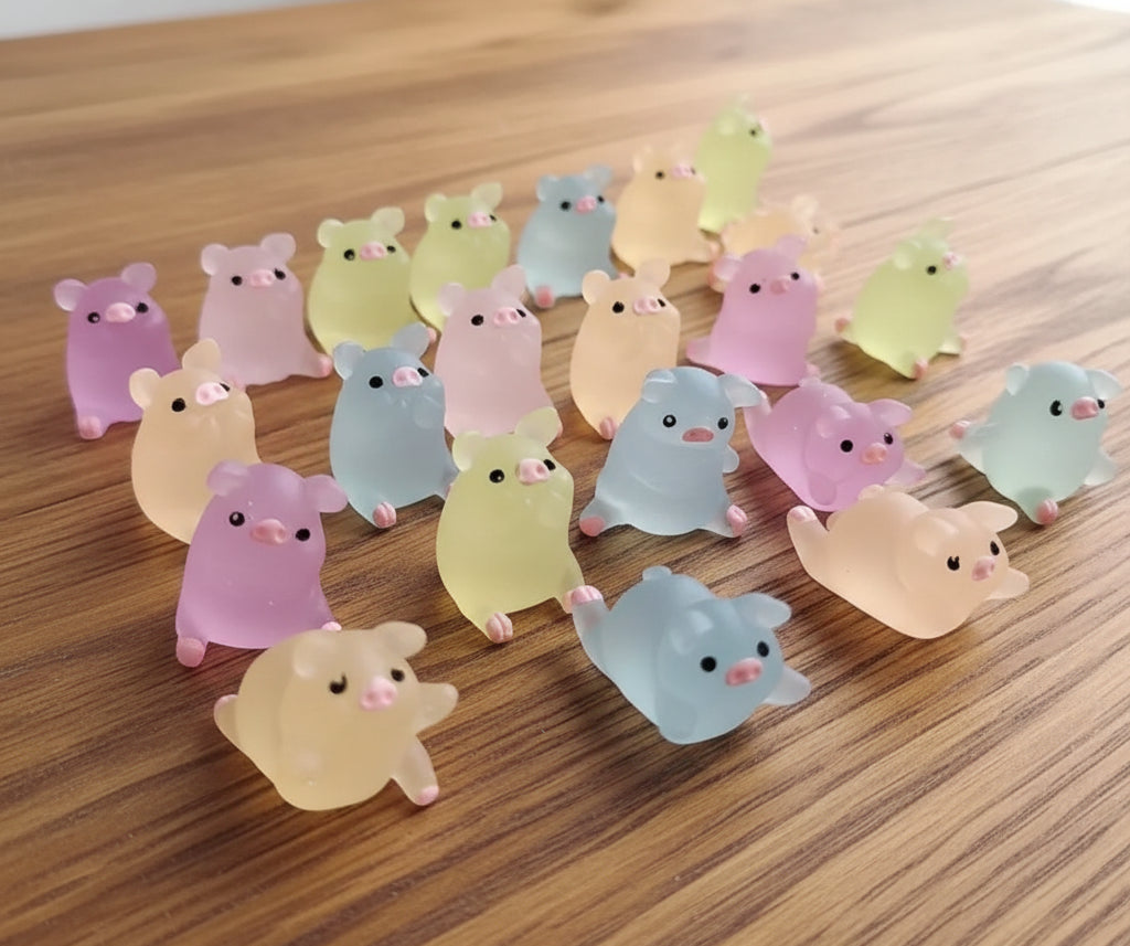 Collection of small, colorful glow in the dark pigs