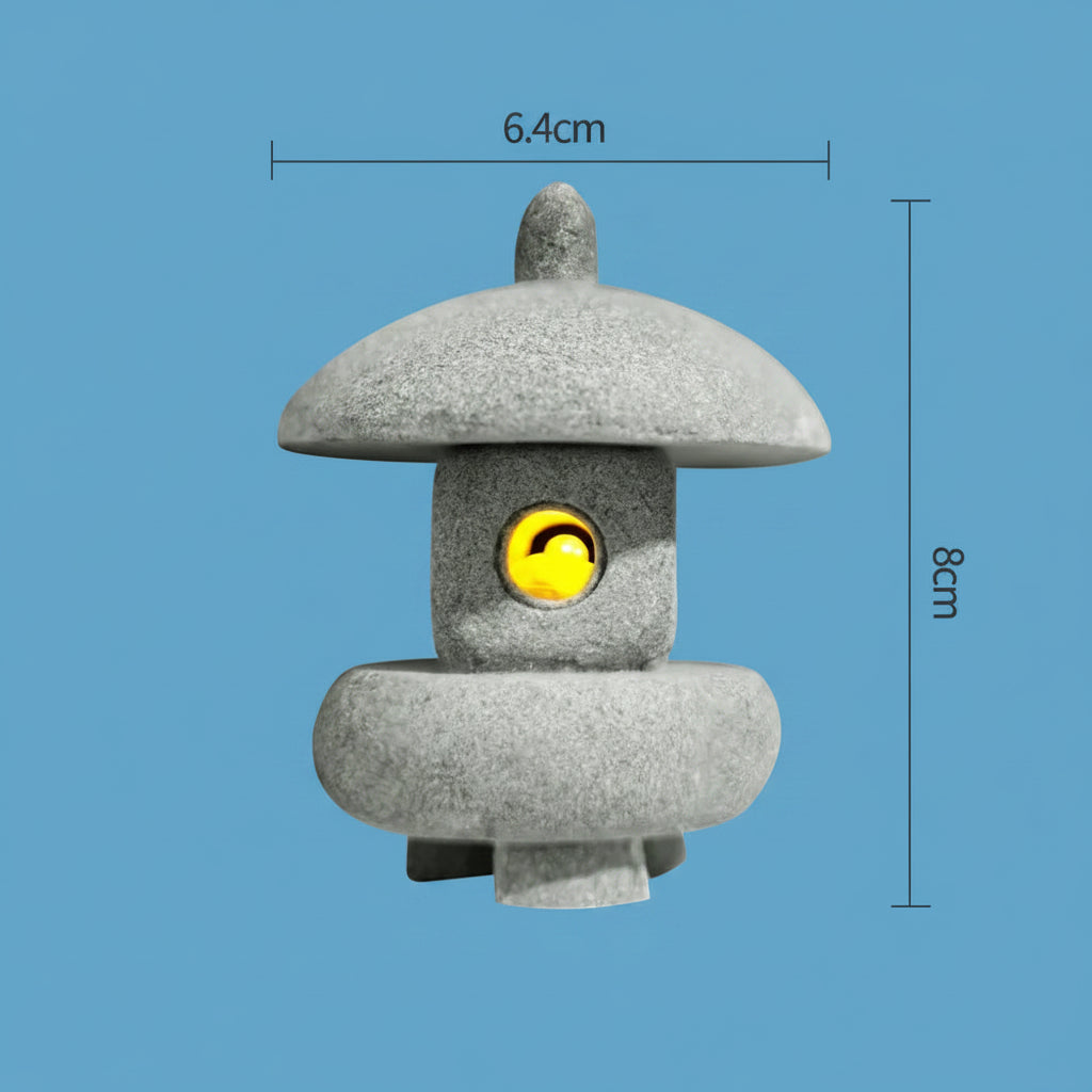 Small japanese style stone lantern with a yellow light bulb inside, shown with dimensions on a light blue background.