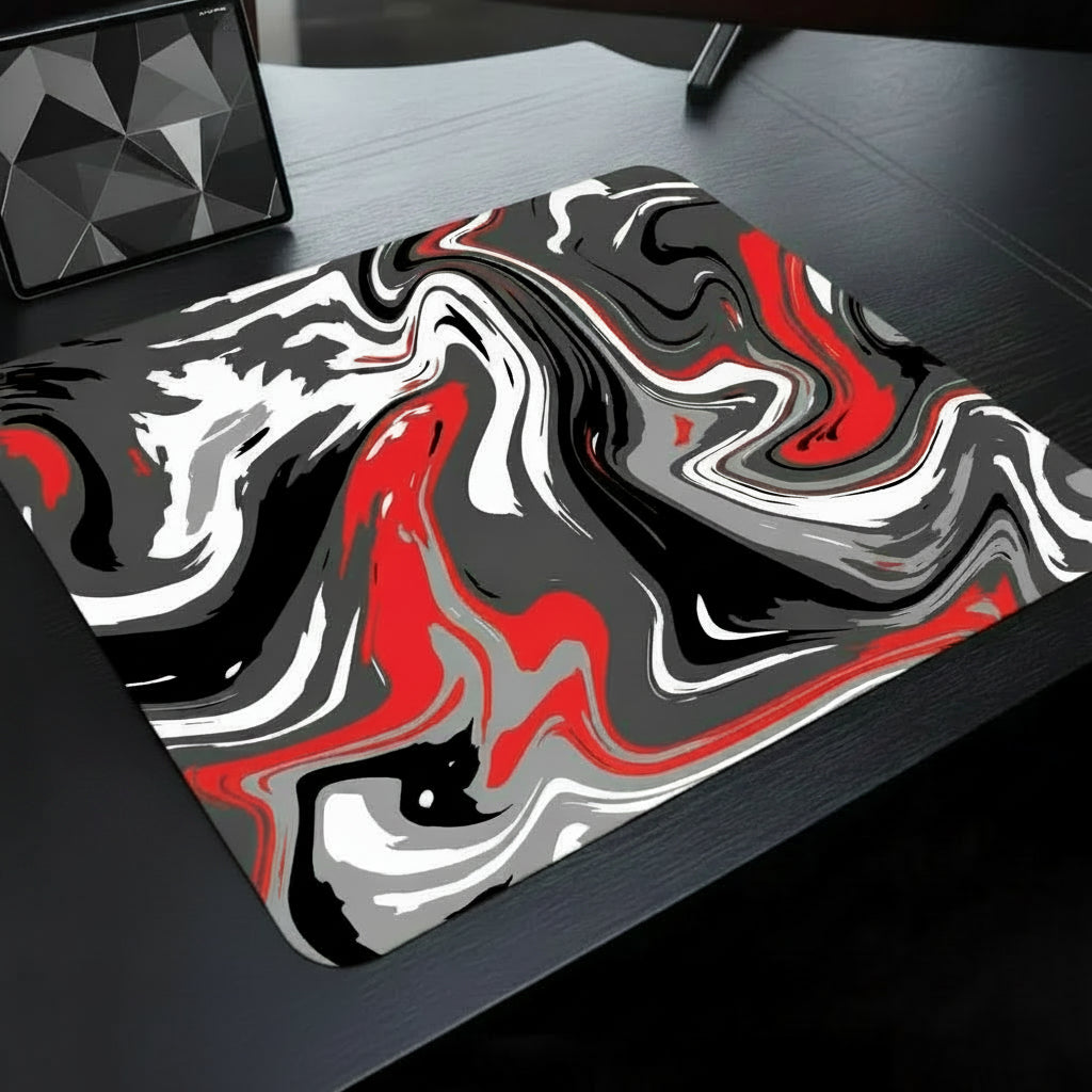 Marbled red, black, and white mouse pad on a desk