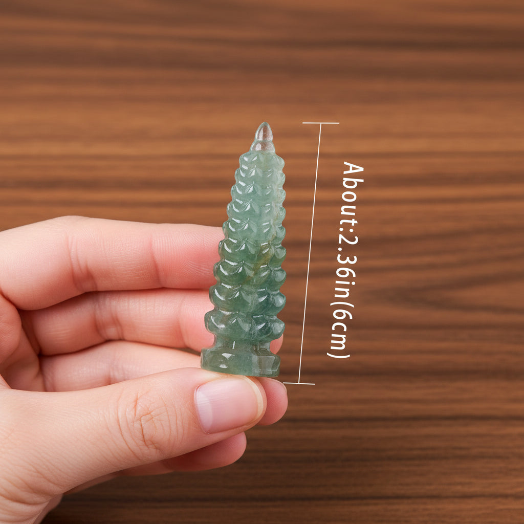 Hand holding a green crystal with measurement details