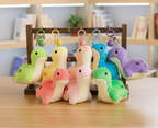 Colorful plush dino toys with keychains on a wooden stand against a light-colored wall.