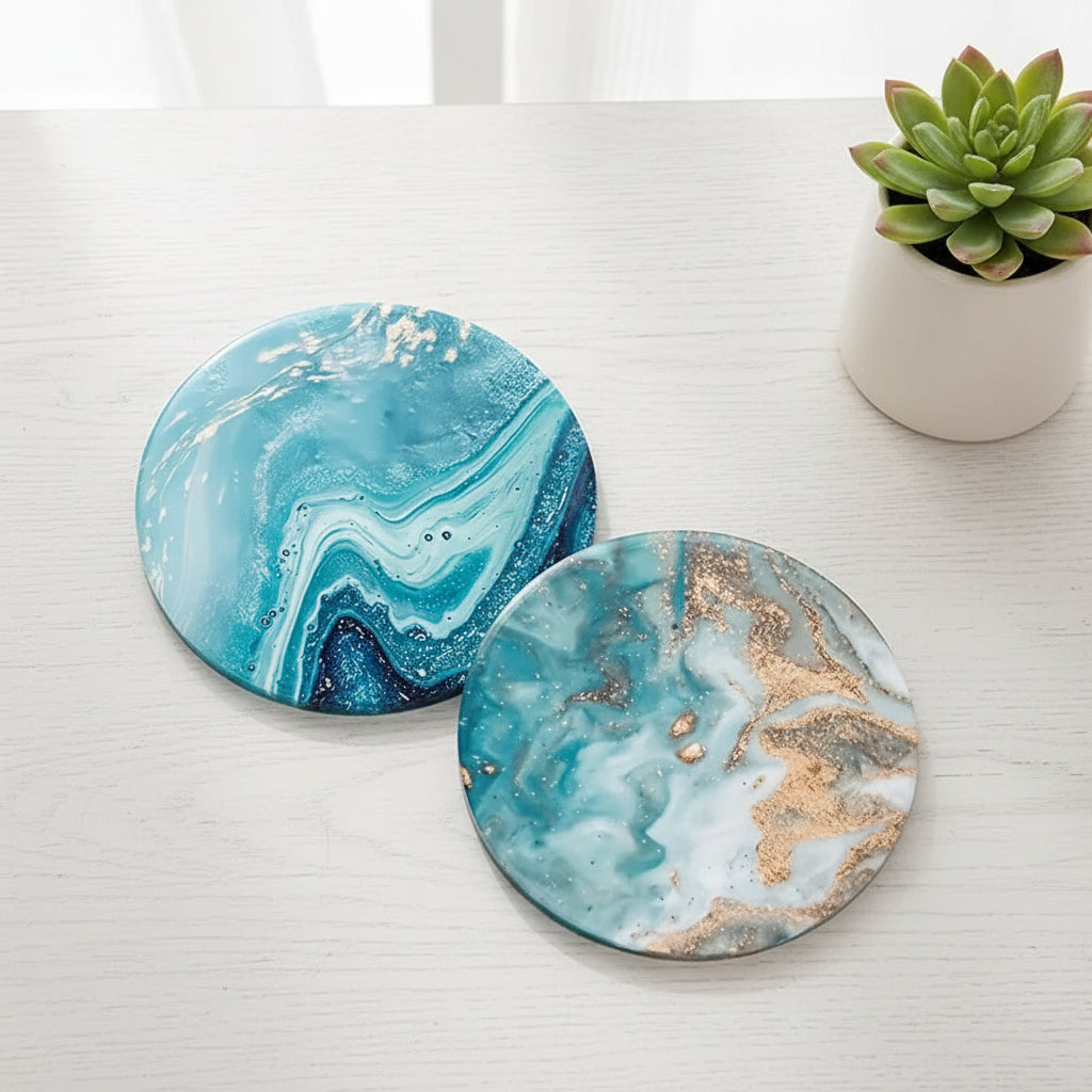 Two round marbleized coasters with blue and gold patterns on a light green background.