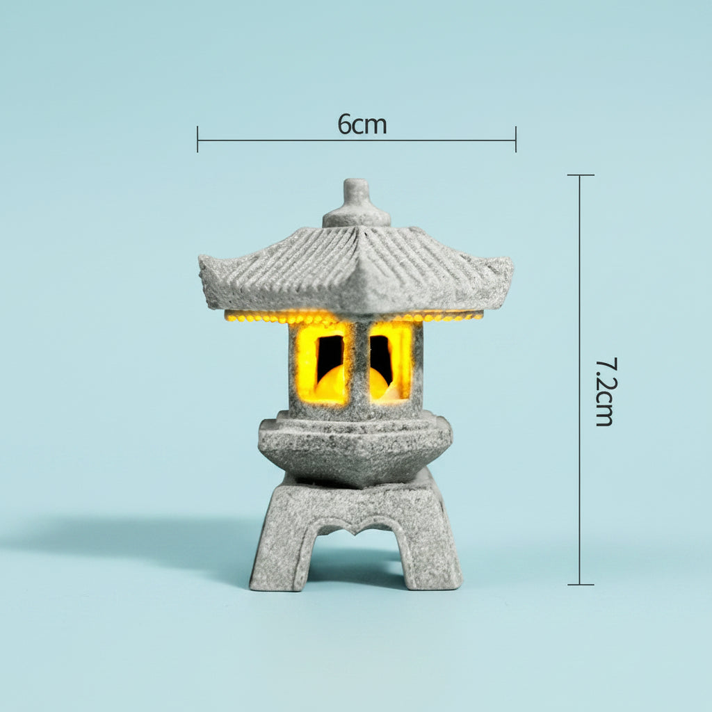 Decorative japanese style stone lantern with yellow glowing light inside, shown with measurements on a light blue background