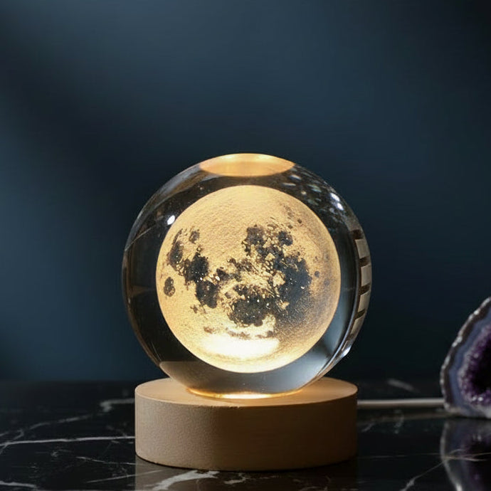 Moon lamp with a wooden base on a dark surface