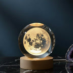 Moon lamp with a wooden base on a dark surface