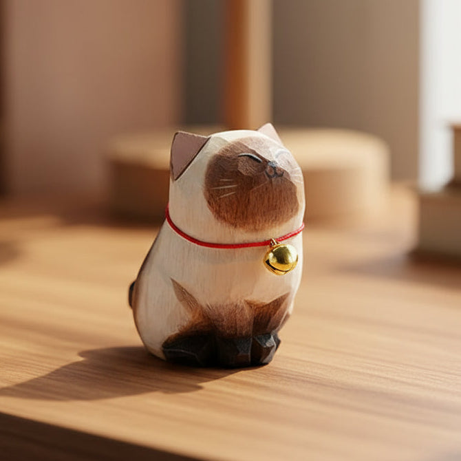 Cat-shaped tea bag with a gold tag on a wooden surface