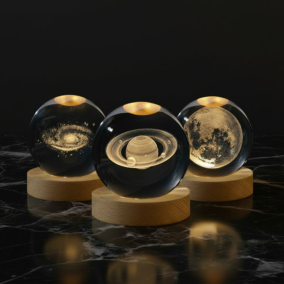 Three space planets crystal ball night lights displaying celestial designs on wooden bases.