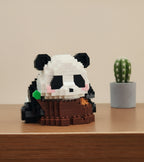 Hand holding a panda-shaped toy made of interlocking bricks