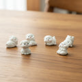 White dog figurines on a table