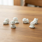 White dog figurines on a table