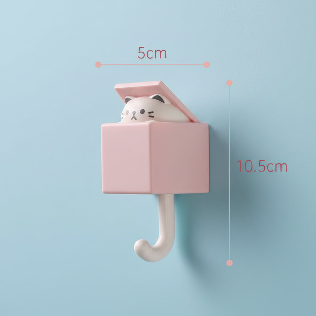 Pink wall hook with a cat-shaped cushion, showing dimensions on a blue wall
