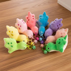 Colorful animal-shaped keychains on a light gray background