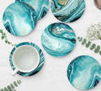 Set of blue marbled coasters with a white mug on a light surface.