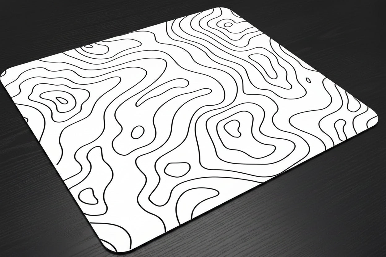 White mouse pad with black line art design on a dark surface