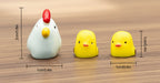 Three small rubber duck toys with measurements on a wooden surface