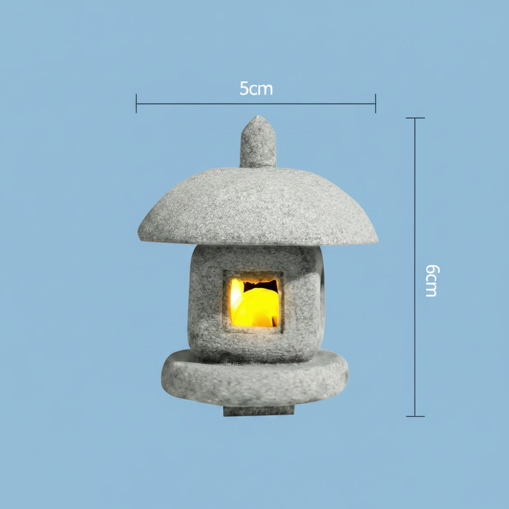 Small japanese inspired stone lantern with a glowing interior on a light blue background, showing dimensions.