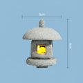 Small japanese inspired stone lantern with a glowing interior on a light blue background, showing dimensions.