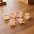 Set of six small pig figurines on wood desk