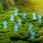 Transparent ghost-like figures with black eyes and green mouths on a grassy surface.