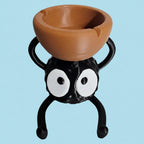 Spider-shaped planter with a brown bowl on a white background