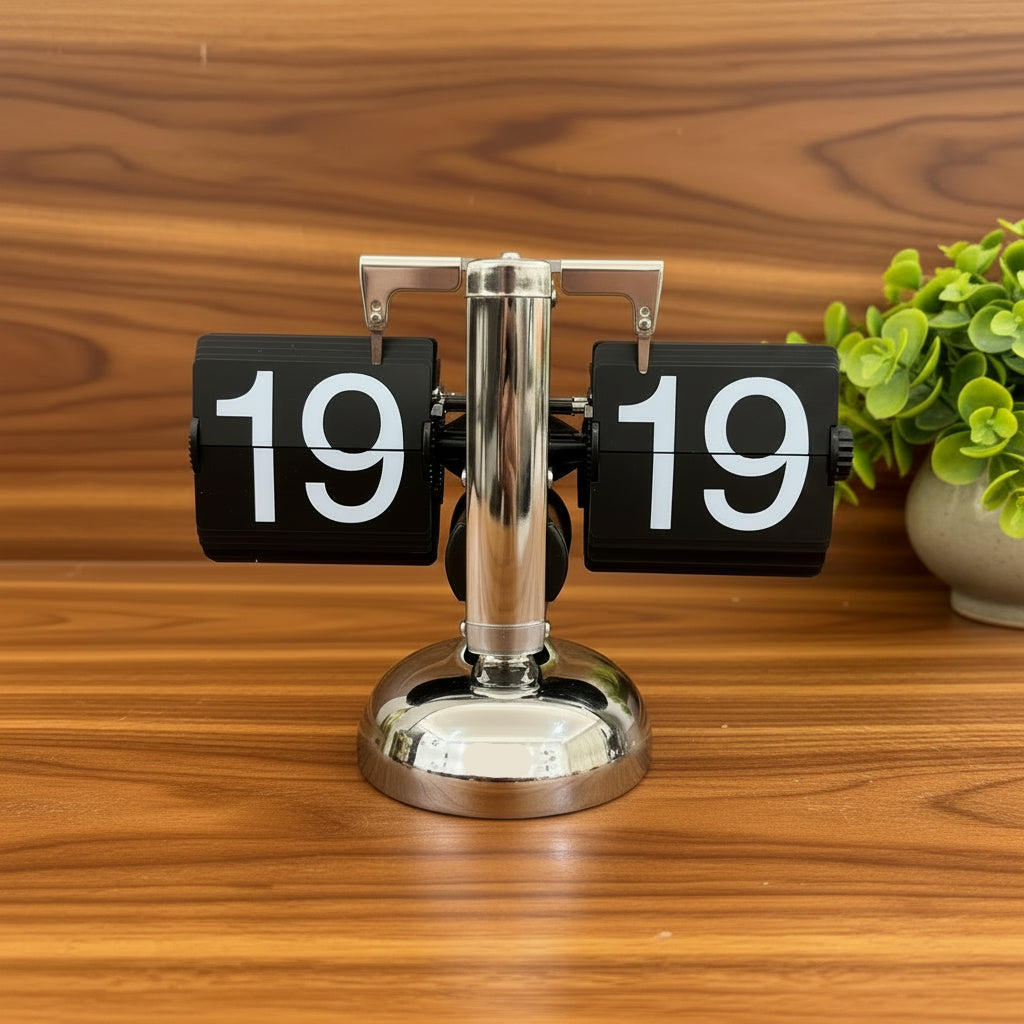 black flip clock with white numbers and silver base