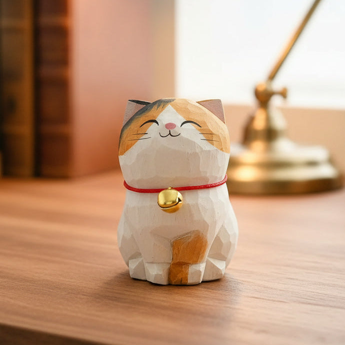 Cat-shaped decorative item on a wooden surface with books and a lamp in the background