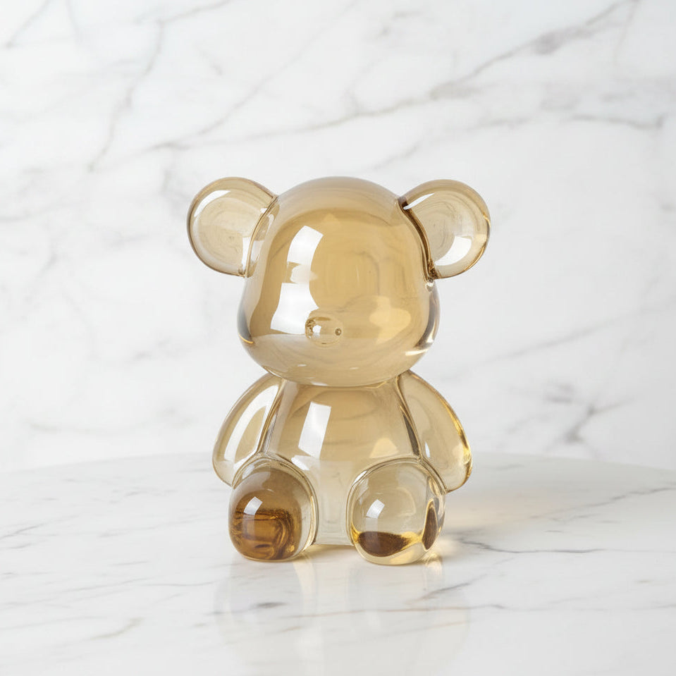 Clear amber-colored bear-shaped object on a marble surface