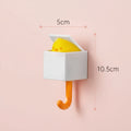 White wall hook with a yellow sponge inside, showing dimensions on a white background