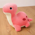 Pink dinosaur plush toy on a light background