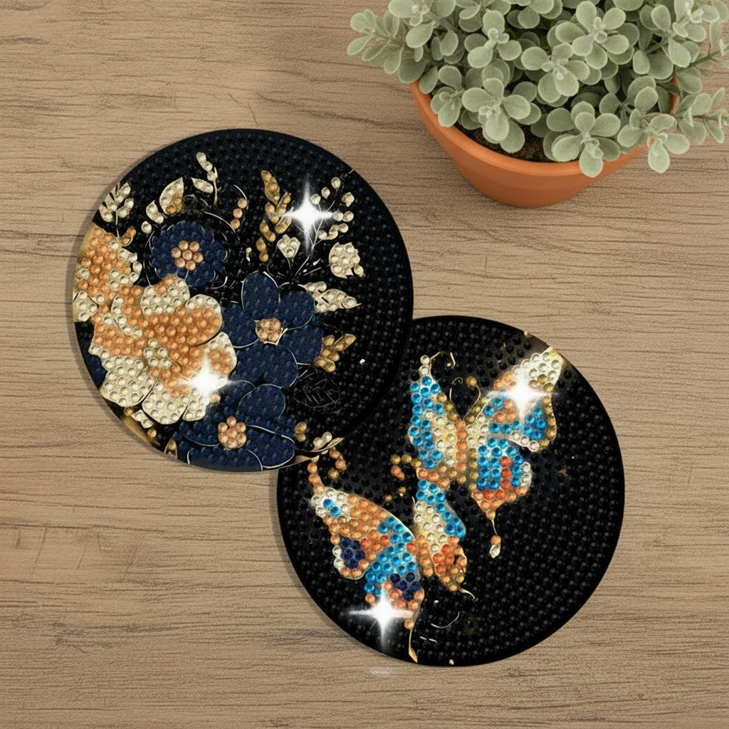 Two round diamond painting coasters with butterfly and floral designs on a light blue background.