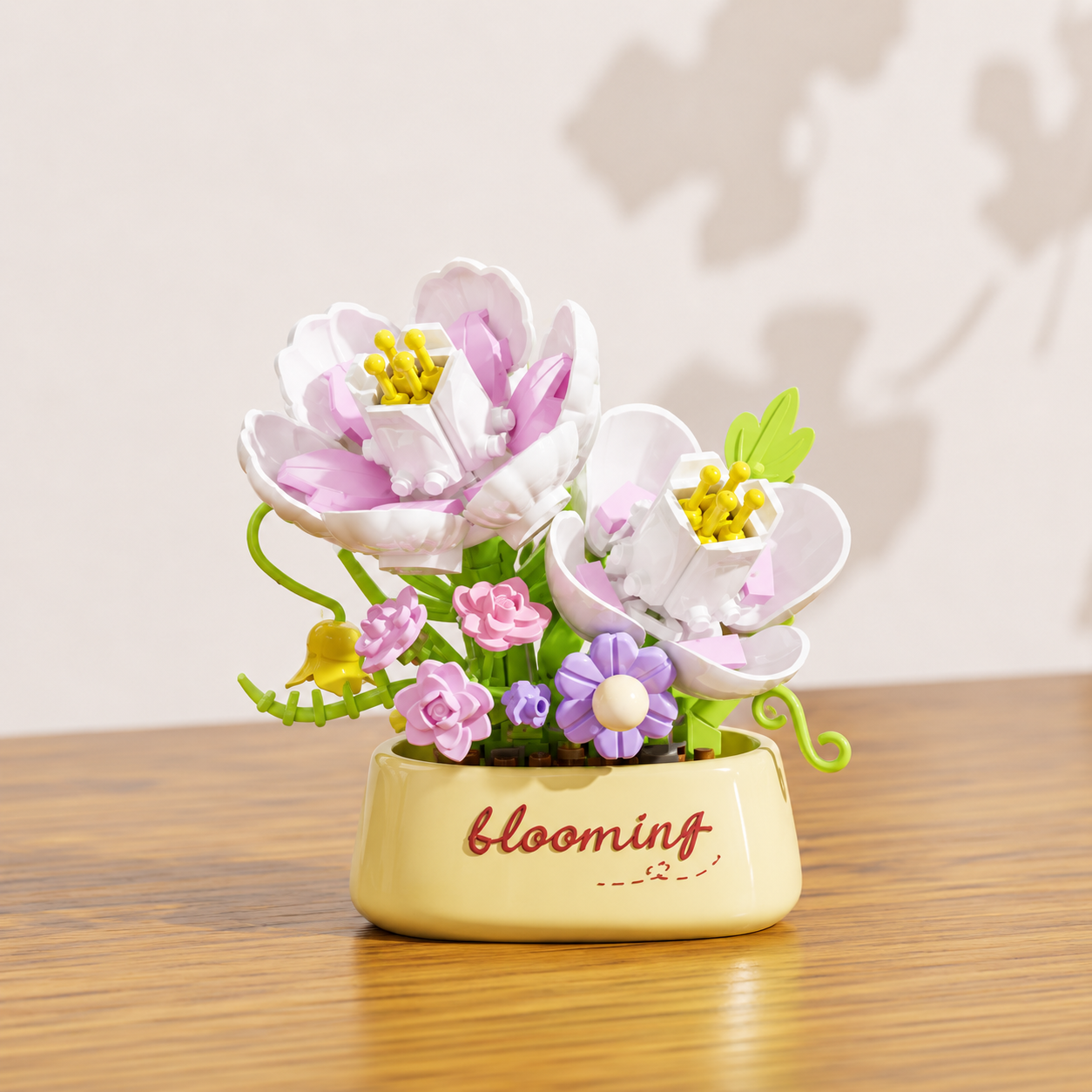 Decorative white and pink building brick flowers in a flower pot on a wooden surface